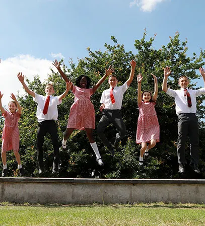 group photo of students jumping midair